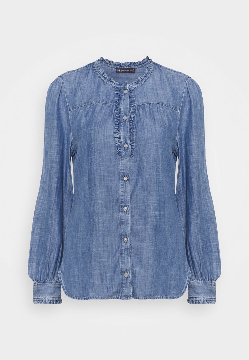 Camicia in denim a bottoni, di colore azzurro chiaro, maniche lunghe con spalle a palloncino, patta frontale arricciata e texture liscia. Orlo arrotondato e bottoni argentati.