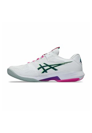 White low-top athletic shoe with green logo, pink and purple accents, and textured sole designed for sports performance.