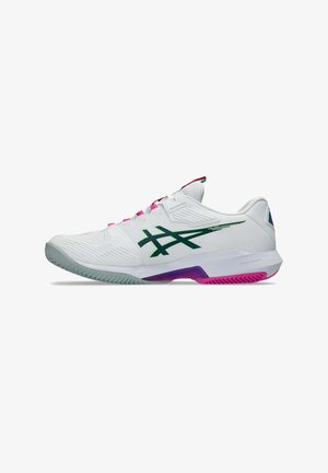 White low-top athletic shoe with green logo, pink and purple accents, and textured sole designed for sports performance.