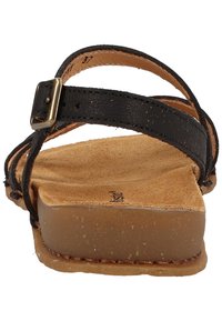 Black leather sandal with two adjustable straps, a textured insole, and a light brown rubber sole. Accent buckle on strap.