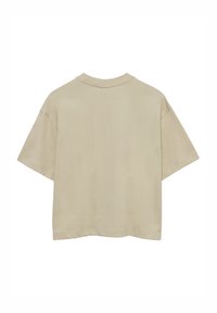 Beige katoenen t-shirt met een ontspannen pasvorm, korte mouwen en een ronde hals. Het heeft een effen textuur zonder zichtbare patronen of hardware.