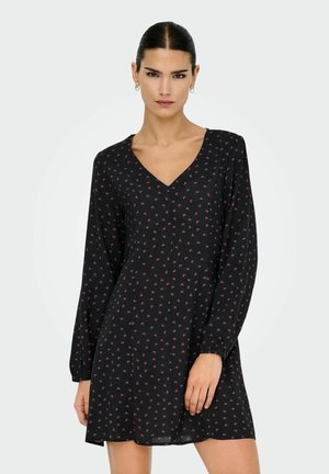 Robe noire à manches longues, décolleté en V, avec de petites motifs floraux roses. Matière fluide, légèrement en forme A, avec des poignet resserrés.