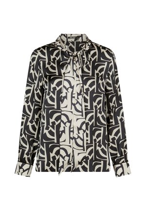 Black and white long-sleeve blouse with abstract geometric pattern and a tied neck bow detail.