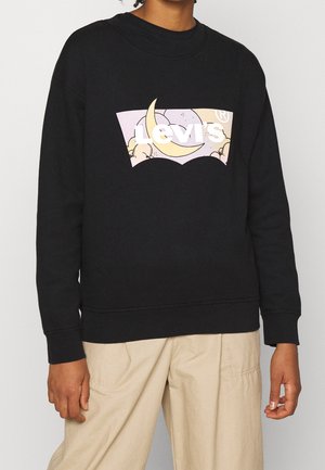 Svart sweatshirt i bomull med ett tryck framtill som föreställer en måne och moln, med "Levi's"-logotypen i vitt.