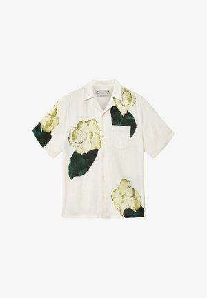 Hvid kortærmet skjorte med knapper, store grønne og gule blomsterprint og en brystlomme.