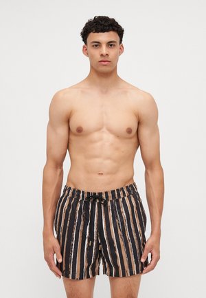 Black and tan striped swim shorts with an elastic waistband, drawstring closure, and a smooth, lightweight fabric texture.