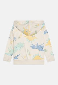 Sweat à capuche pour enfants en crème, orné de motifs colorés de dinosaures et de soleils en bleu, jaune et vert. Tissu doux et ourlet ajusté avec capuche.