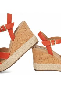 Orange wedge sandals with cork detail. Features a jute-wrapped sole, adjustable straps, and a smooth textured upper. Lightweight design.
