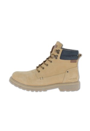 Tan suede ankle boot with blue fabric collar, round toe, and brown accents. Features metal eyelets and a textured rubber sole. Logo on side.