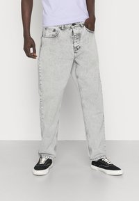 Carhartt WIP NEWEL PANT - Calças de ganga de corte afunilado - black sun washed