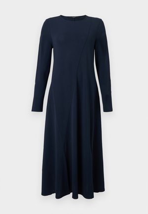 Μπλε φόρεμα με μακριά μανίκια, στρογγυλή λαιμόκοψη και διακριτική διαγώνια ραφή, που ρέει κάτω από το γόνατο.