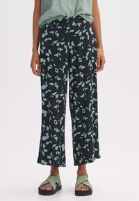 Zwarte broek met wijde pijpen en een muntgroen abstract bloemmotief. Gemaakt van lichtgewicht stof met een elastische tailleband voor comfort.