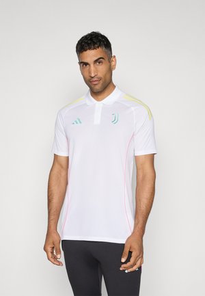 Polo blanc à manches courtes, avec des accents vert menthe, des surpiqûres roses sur les côtés et des rayures jaunes sur les épaules. Logo Adidas présent.