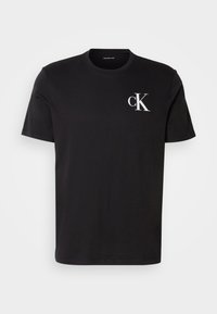 Black cotton short-sleeve t-shirt featuring a white "ck" logo on the left chest. Round neckline and straight hem design.