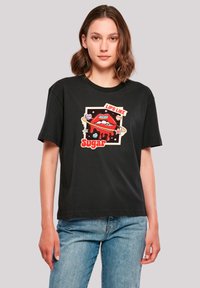 Black cotton t-shirt featuring a graphic of red lips with the text "LIPS LIKE SUGAR," accented with colorful elements and a relaxed fit.