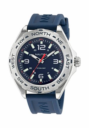 Nautica watch with a navy rubber strap, a round silver stainless steel case, blue dial, luminous hour markers, and a red second hand.