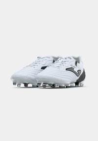 Pair of white and black soccer cleats with laces and plastic studs, viewed from front side on a plain background.