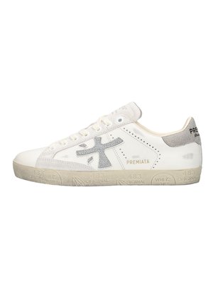 White low-top sneaker with gray textured logo, beige sole with embossed text, and "Premiata" branding on the side and heel tab.