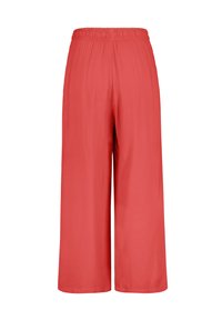 Red wide-leg pants with an elastic waistband, made from smooth fabric, featuring a simple design and no visible embellishments.