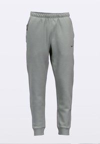 Graue sportliche Jogginghosen aus strukturierter Stoffqualität, mit elastischem Bund und elastischen Bündchen an den Knöcheln. Mit kleinem schwarzem Nike-Logo am Oberschenkel.