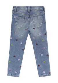 Denim teksad sinise pesuga, kitsas lõige, millel on broderie lille- ja liblikamustrid lilla, roheline ja pruun värv. 