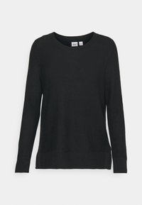 Pull noir à manches longues en tissu maille texturé, avec un col rond et une coupe décontractée. Étiquette visible au niveau du col.