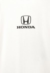 Hvid bomulds-T-shirt med et sort Honda-logo og tekst. Enkel design med rund hals og korte ærmer. Glat tekstur.