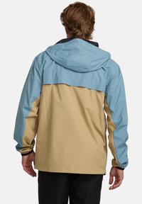 Water-resistant jacket featuring a color-block design in light blue and beige. Includes a hood and elastic cuffs. Smooth texture, minimal hardware.