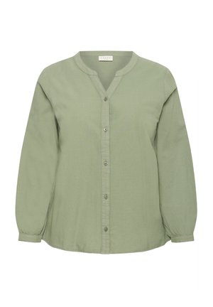 Hele-rohelise tooniga pikkade varrukatega pluus nöörkraega, eest nööpidega ja veidi kurrutatud varrukaotsadega.