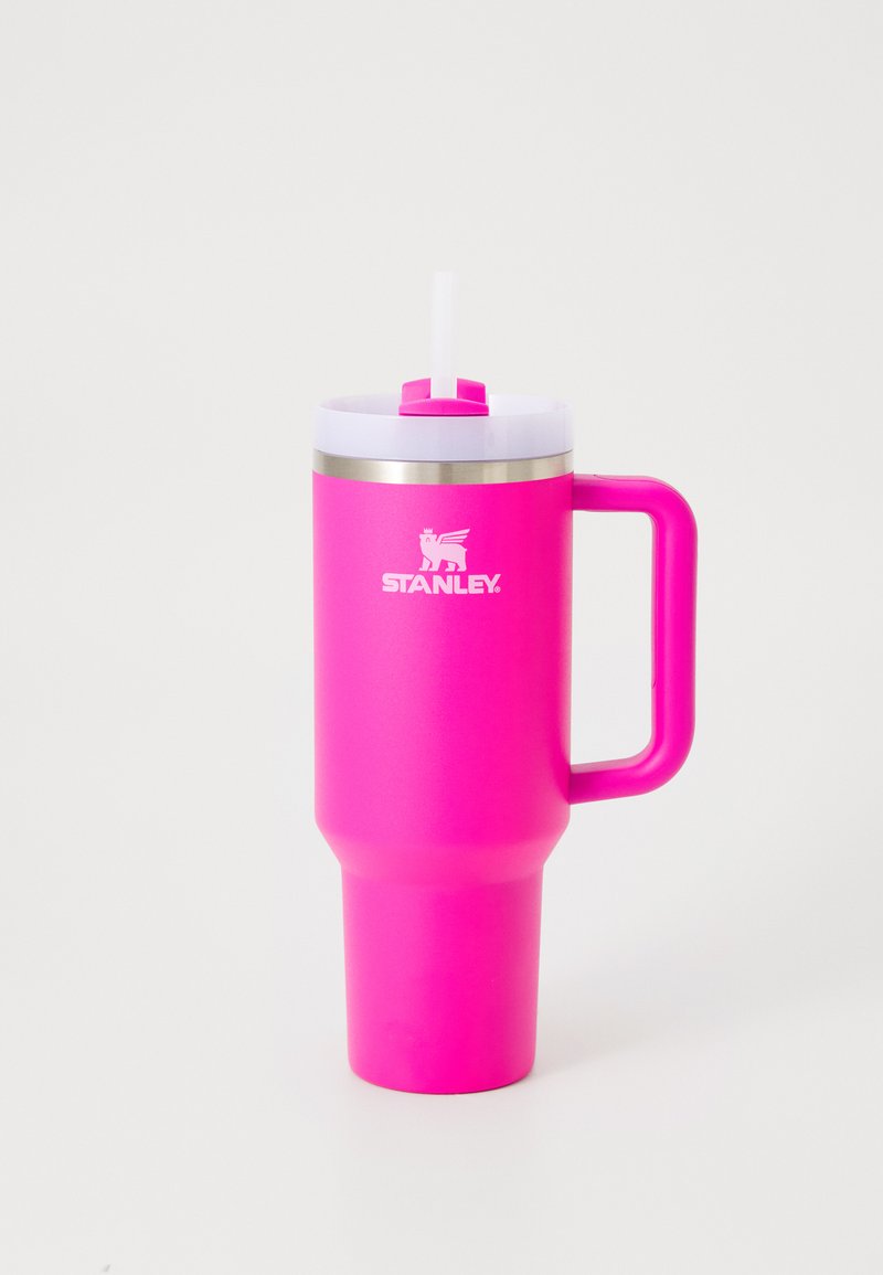 Rosa Edelstahlbecher mit einem weißen Deckel und Strohhalm, ausgestattet mit einem Griff und einem breiten Fuß für Stabilität. "STANLEY"-Logo sichtbar.