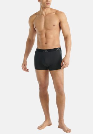 Čierne športové boxerky vyrobené z elastického materiálu s hladkou textúrou, s brandovaným elastickým pásom a priliehavým strihom.