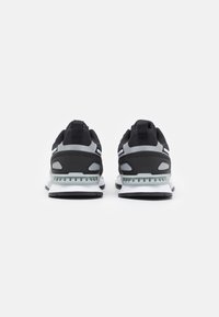 Black and gray athletic shoes with a mesh upper, padded collar, reflective accents, and a white midsole. The outsole features a textured pattern.