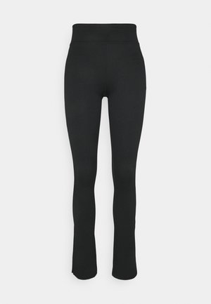 Leggings pretas com textura canelada, cintura alta, fundo flare e textura suave. Sem padrões visíveis ou detalhes de hardware.