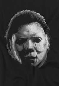 Black t-shirt featuring a detailed graphic of a pale, expressionless mask with tear-like streaks, surrounded by dark hair and shadows.