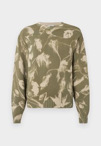 Žalias megztinis su lapų raštu kremine spalva. Šonai ir rankogaliai įsiūti, apvali kaklo išpjova ir atsipalaidavęs siluetas. Turi tekstūruotą medžiagos dizainą.