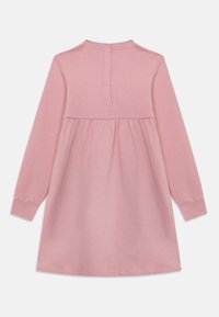 Robe longue rose à manches longues avec un col rond, buste froncé et fermeture à boutons au dos. Fabriquée en tissu doux avec une texture lisse.