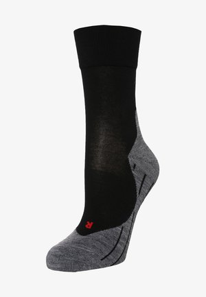 Chaussette noire et grise avec une partie supérieure côtelée, un talon et un orteil renforcés, accentués par un logo rouge. Le matériau a une texture lisse.