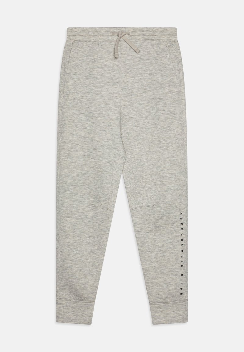 Gray sweatpants made of soft, textured fabric. Features an elastic waistband with drawstring and printed logo along the left leg.