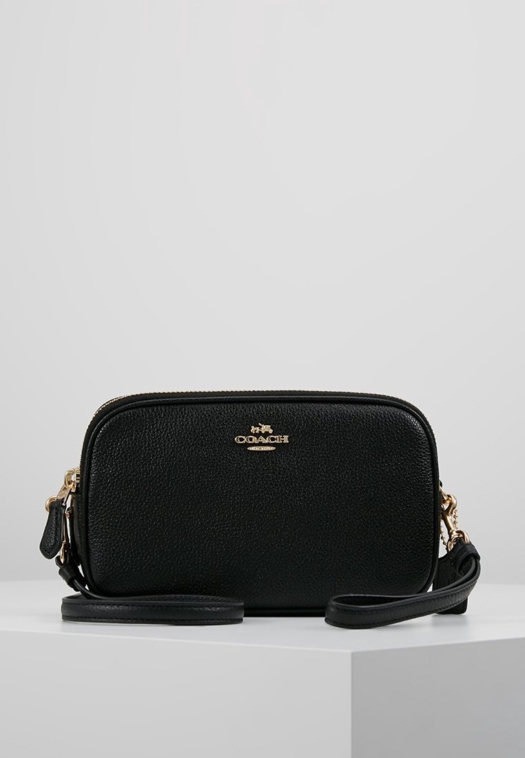 Mustakiminen nahkainen olkalaukku, jossa on rakenneviimeistely, kultaiset varusteet, vetoketjukiinnitys ja sä ädettävä hihna. Kompakti suorakaiteen muotoinen.