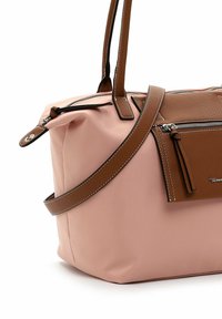 Sac à main rose doux avec poignées en cuir marron, garniture et une petite pochette zippée fixée à l'avant.