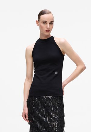 Black sleeveless top with a textured, sparkly neckline and fitted design. Features a small logo on the lower side.