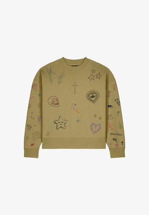 Beige sweatshirt with black, purple, and red doodles including stars, skull, heart with eye, birds, cactus, and text on front and sleeves.