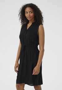 Schwarzes ärmelloses Kleid mit Knopfleiste, Kragen und elastischem Bund. Leichter Stoff mit glatter Textur und knielangem Design.