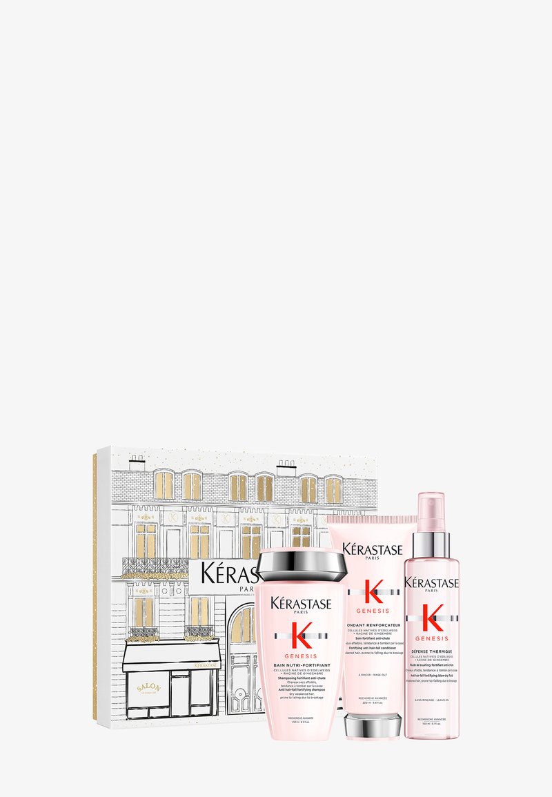 Il set regalo Kérastase Genesis include tre prodotti rosa: uno shampoo, un balsamo e uno spray per lo styling, il tutto in una confezione decorativa con un'illustrazione parigina.
