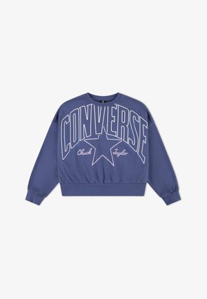 Lila pulóver nagy fehér "CONVERSE" felirattal és csillag grafikával. Hosszú ujjú, bordázott mandzsettával és testhez simuló szegéllyel. Pamut keverék anyagból.