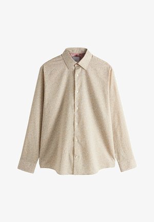 Chemise boutonnée beige clair avec un petit motif floral en orange et bleu. Elle présente un col classique et des manches longues avec une coupe décontractée.