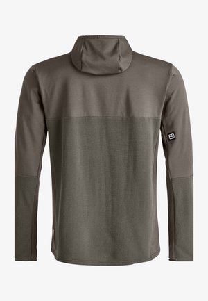 Dark green long-sleeve hooded top featuring a textured back and smooth sleeves, with contrasting fabric and a logo on the left arm.