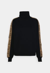 Suéter de cuello alto azul marino con mangas largas. Presenta rayas laterales en tono beige con el texto "Calvin Klein Jeans". Fabricado en una tela suave.