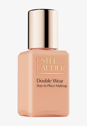 Estee Lauder Double Wear foundation in a square glass bottle with a peach tint, gold metallic lid, and black text on the front.