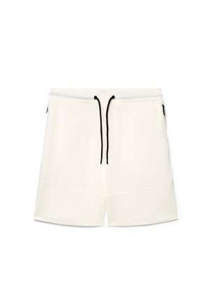 Pantaloncini casual bianchi con coulisse nera in vita elasticizzata, tasche laterali con cerniere e un dettaglio di cucitura semplice vicino all'orlo.